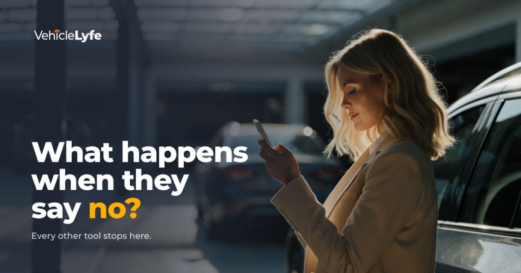 A dealership service drive customer reading a message on her phone